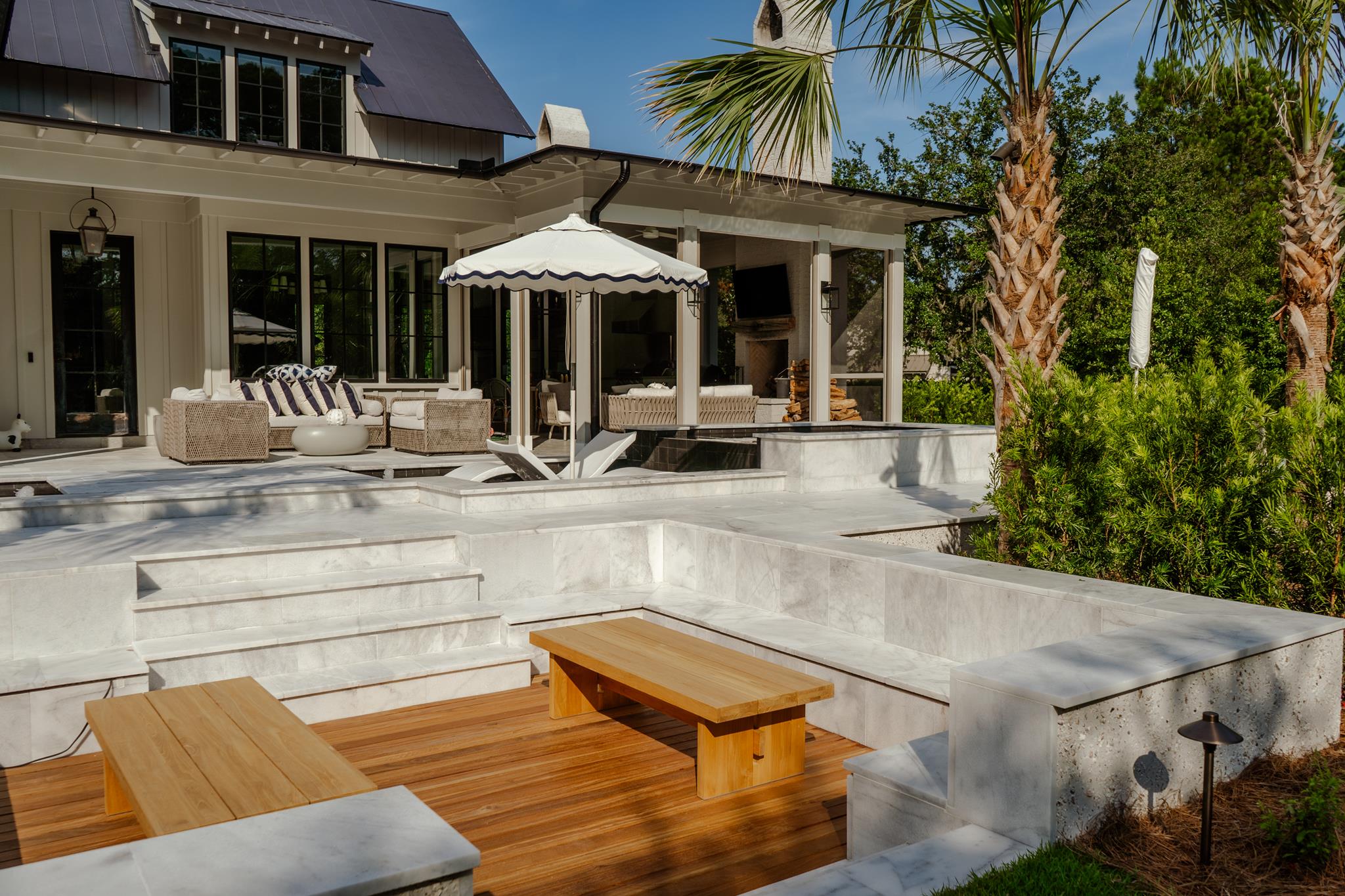 Pool with tanning ledge and lounge chairs in a Bluffton SC backyard