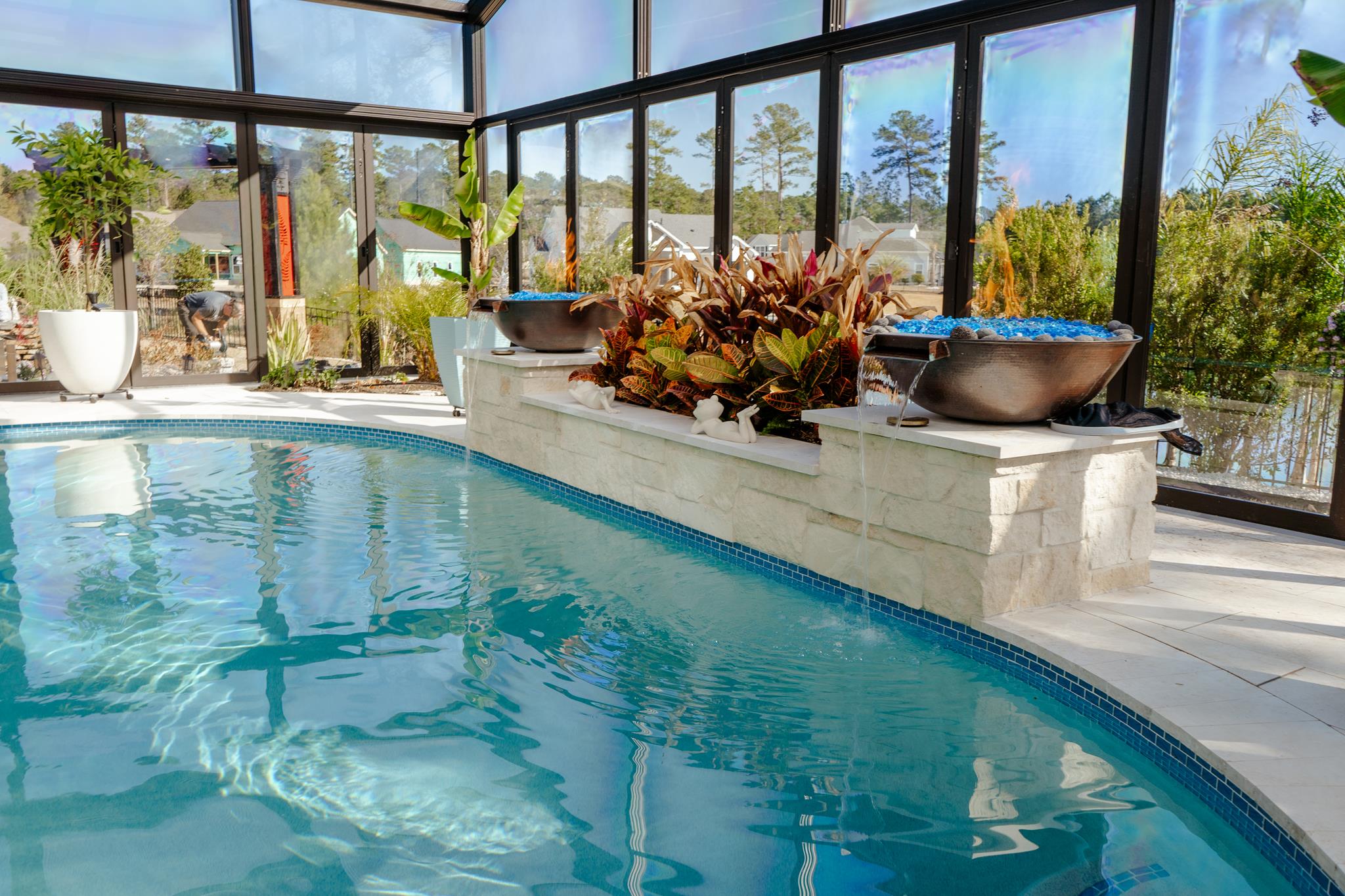 Outdoor living space with pool, fire feature, and ambient lighting in the Lowcountry